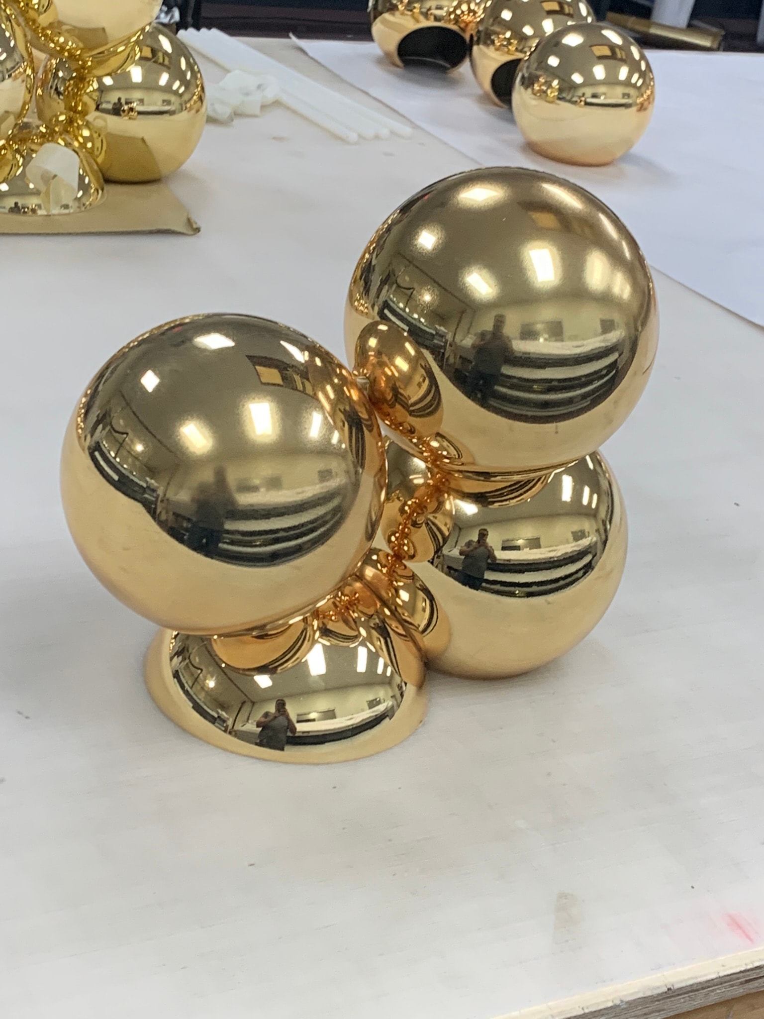Rose gold and gold chrome-painted dome sculptures in VVG workshop
